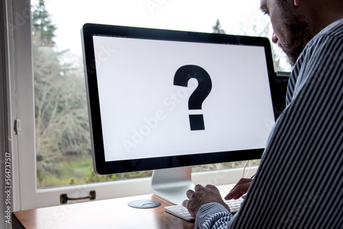 Using a computer to search concept. Computer screen with large question mark. 