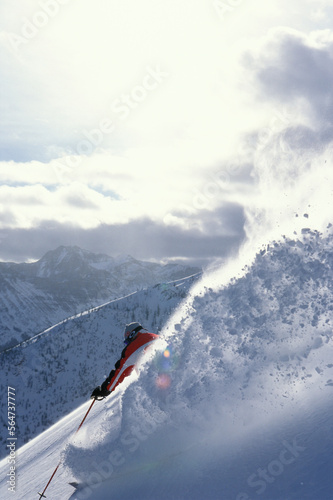 Male skier (Sven Brunso) skiing deep powder on photo