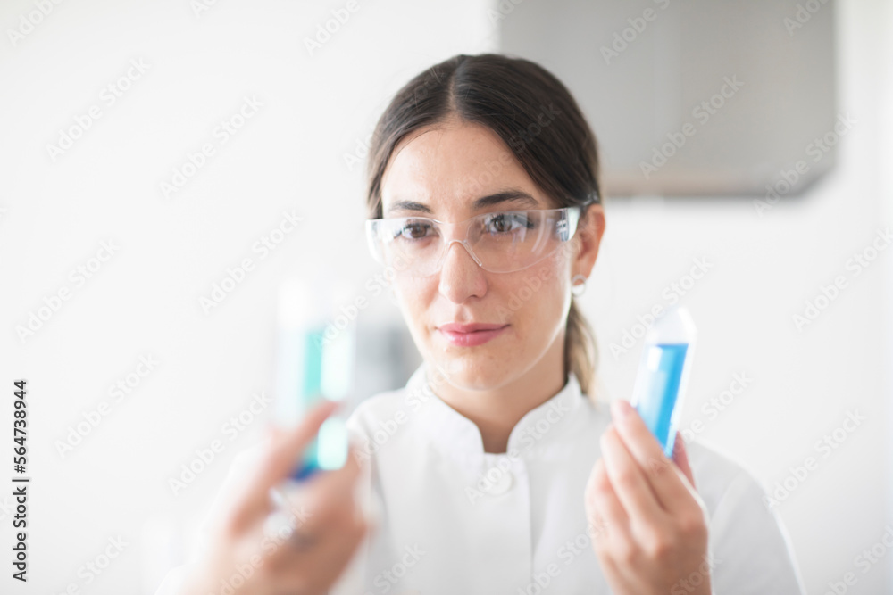 scientist female with lab glasses, tablet and sample in a lab scientist female with lab glasses, tablet and sample in a lab