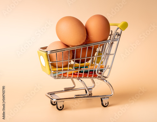 Chicken eggs pile in shopping cart, trolley