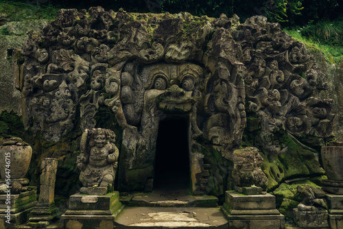 Demon carvings on entrance of cave temple photo