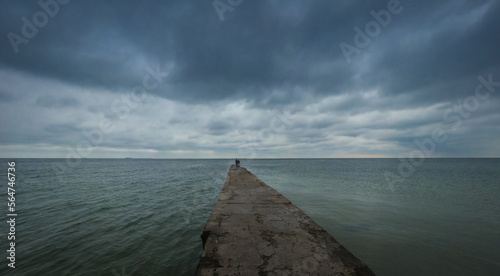 Otrada beach in Odessa, Ukraine, in a gloomy summer morning. Dark clouds asperatus over the sea until dawn. photo