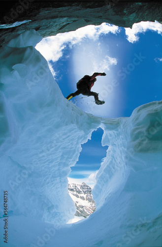 A man jumps over a Crevasse. photo