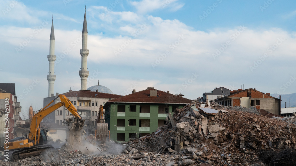 Urban transformation, the process of redevelopment and revitalization of urban areas. Excavators in construction site demolishing old buildings in Golcuk Kocaeli Turkey. Selective focus included.