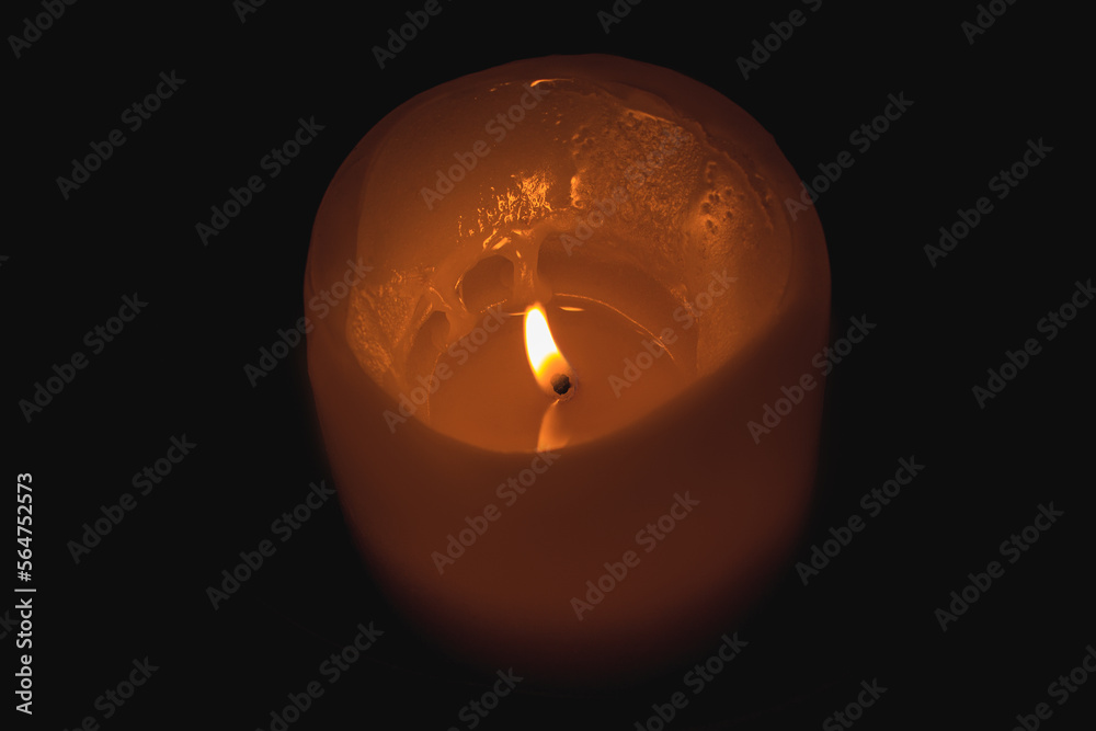 The flame of a burning yellow candle in close-up. The flame of a burning yellow candle in close-up.