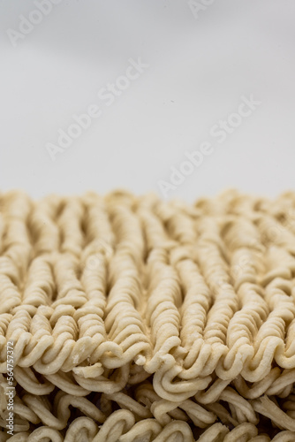 Dry instant ramen noodles on white background.