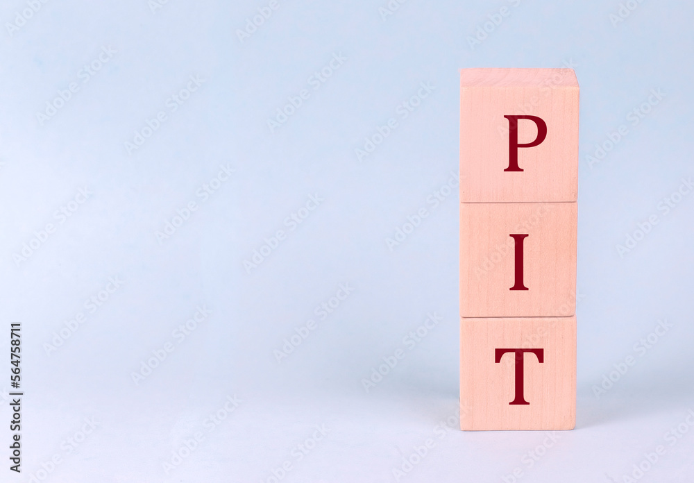 PIT on wooden cubes on a blue background PIT on wooden cubes on a blue background