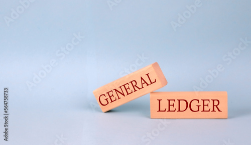 GENERAL LEDGER text on the wooden block, blue background