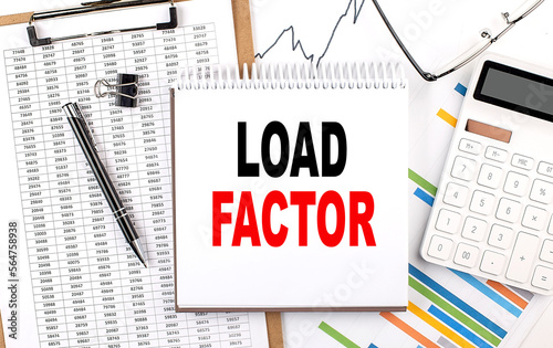 LOAD FACTOR text on notebook with chart, calculator and pen photo