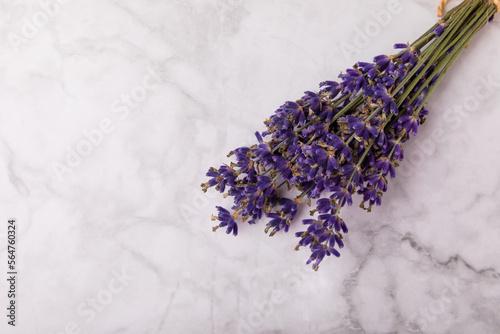 Bouquet of fragrant lavender on a white marble background. Top view. Place for text. Copy space.