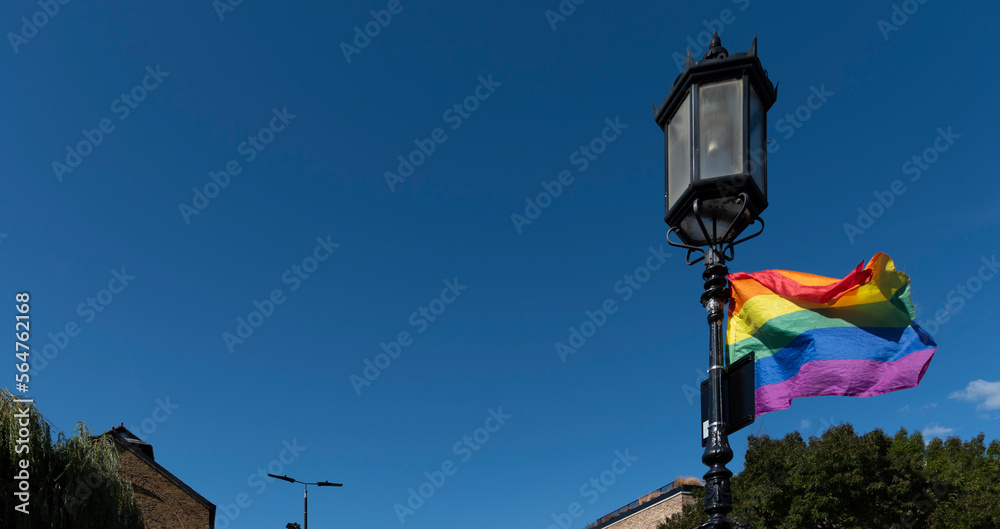 Lgbt flag with background on blue sky with copyspace. Lgbt banner. Colors as symbol human freedom. Homosexuality. 