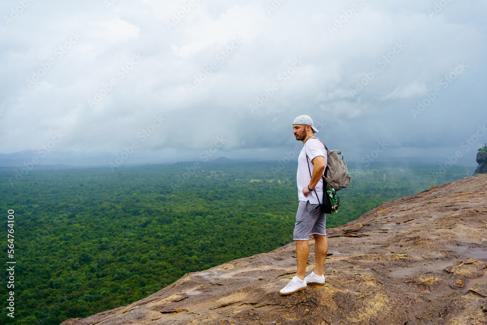 Pidurangala rock. Sri Lanka. Young man looks on the landscape. Pidurangala rock. Sri Lanka. Young man looks on the landscape.