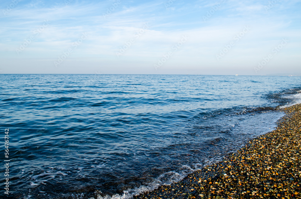 Sea, horizon, beach, pebbles, blue sky