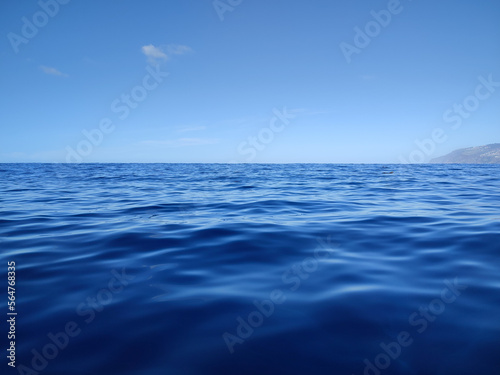 blue water of the ocean and a cloudless sky 
