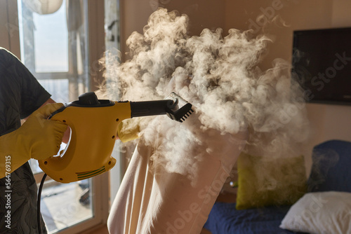 man steaming pillow at home, closeup view. photo