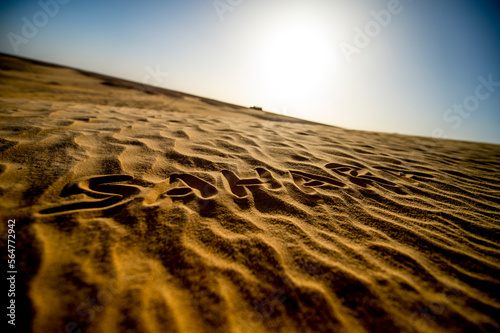 Sahara written in the desert sand photo