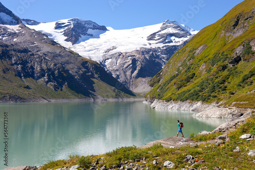 A male hiker near the Mooserboden lake, during the Glocknerrunde, a 7 stage trekking from Kaprun to Kals around the Grossglockner, the highest mountain of Austria. photo