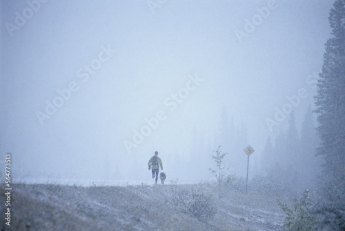 Woman running in snow storm. photo