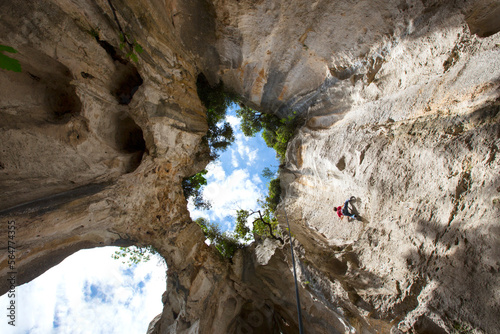 Rock climber in Grotta dell Edera, Finale Ligure, Liguria, Italy photo