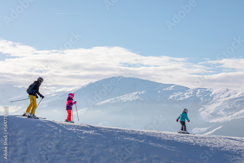 man and woman skiing and snowboarding in the mountains  ski resort
