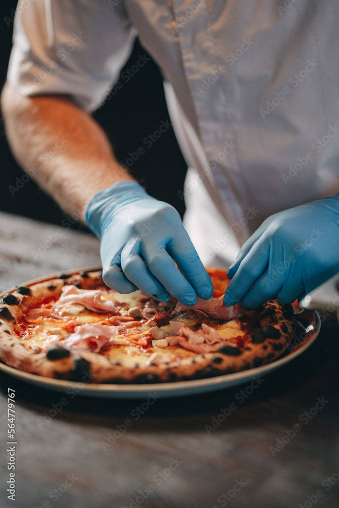 restaurant chef preparing pizza