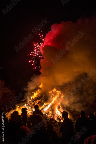 People Amidst Bonfire Against At Night, Dardago, Friuli, Italy photo