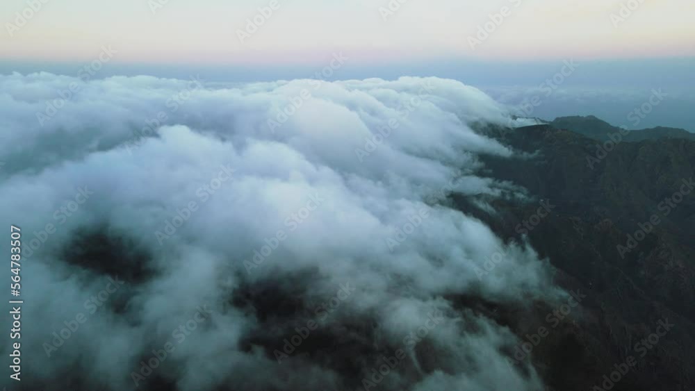 Filmic View of Billowing Clouds on Top of Mountain Peak, Spain Dusk Filmic View of Billowing Clouds on Top of Mountain Peak, Spain Dusk