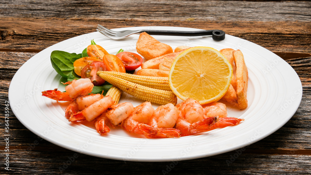 Close up from seafood on plate with lemmon on rustic table Close up from seafood on plate with lemmon on rustic table
