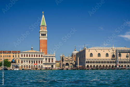 Authentic view of Piazza San Marco from the water on a sunny day, real tourists on the main street of Venice near the seaside admire the beautiful sights, interesting holidays and travels in Italy © Александр Бочкала