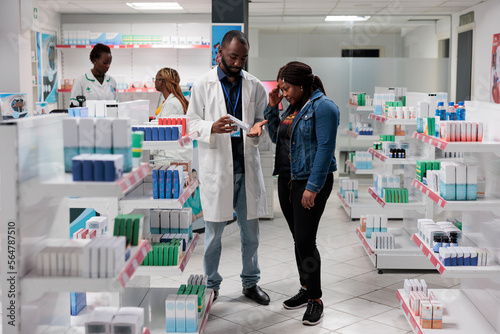 Fotografie Customer buying headache painkiller, pharmacy consultant recommending buyer pills