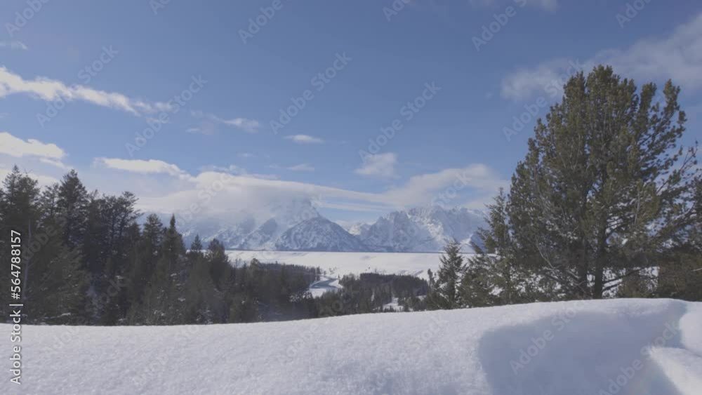 Low angle handheld shot of the Teton range in western Wyoming with snow in the foreground. Shot i 4K Low angle handheld shot of the Teton range in western Wyoming with snow in the foreground. Shot i 4K