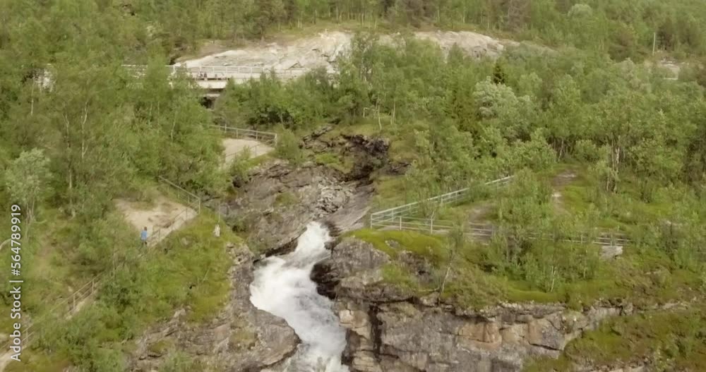 Aerial view of Rovijokkfossen waterfall on the E8 Nordlysveien road in summer, Storfjord, Troms og Finnmark, Norway. Aerial view of Rovijokkfossen waterfall on the E8 Nordlysveien road in summer, Storfjord, Troms og Finnmark, Norway.