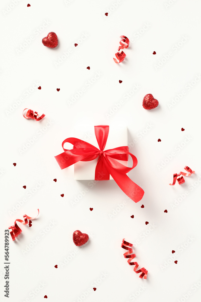 Valentine's Day gift box on a white background with confetti and party streamers. Minimalist style Valentine's Day gift box on a white background with confetti and party streamers. Minimalist style