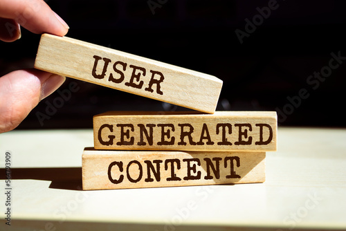 Wooden blocks with words 'USER GENERATED CONTENT'. Business concept