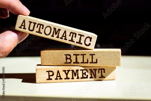 Wooden blocks with words 'AUTOMATIC BILL PAYMENT'. Business concept