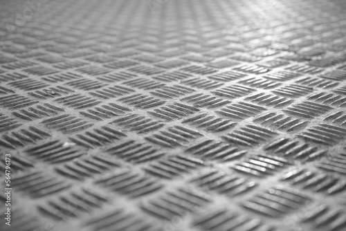 Metallic aluminum background with texture detail of a slip metal floor background in perspective.
