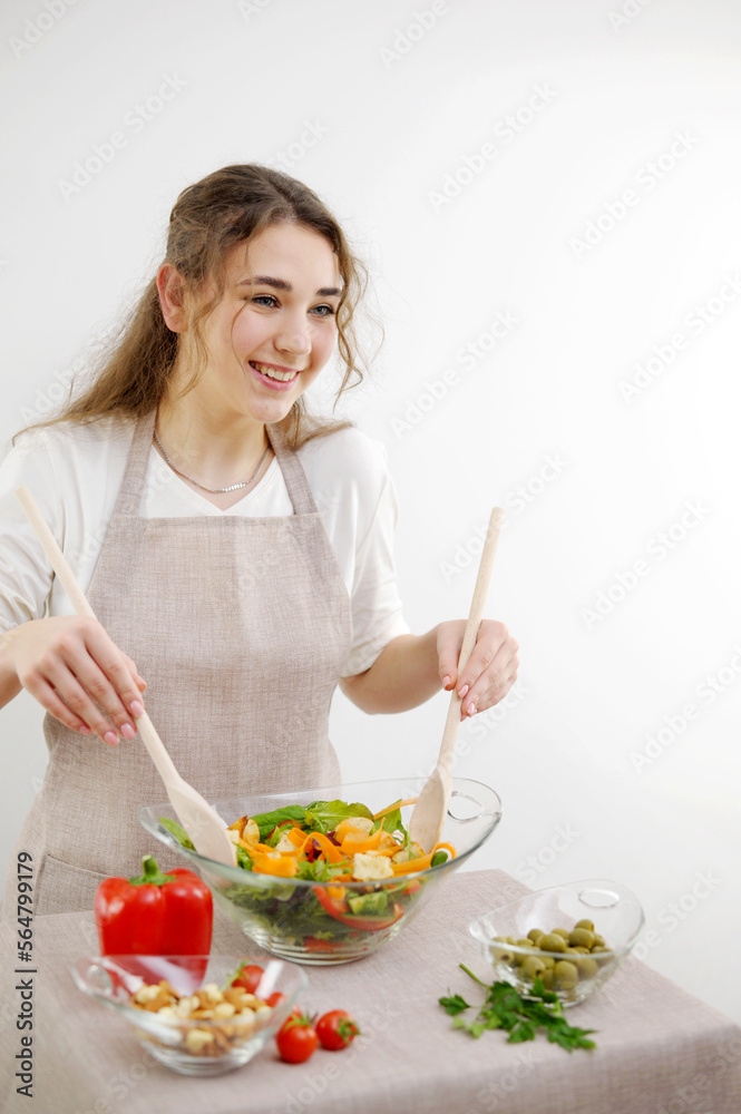 Smiling young woman serving fresh salad on plate Green vegan salad tomatoes and fresh vegetables white background Healthy fresh tomato, cucumber, onion, spinach, lettuce and sesame on plate. Diet menu Smiling young woman serving fresh salad on plate Green vegan salad tomatoes and fresh vegetables white background Healthy fresh tomato, cucumber, onion, spinach, lettuce and sesame on plate. Diet menu