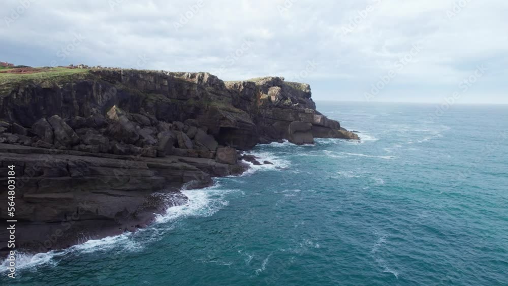 Drone Flying Low Around Rocky Beach On Blue Ocean Shore, Ajo, Cantabria, Spain