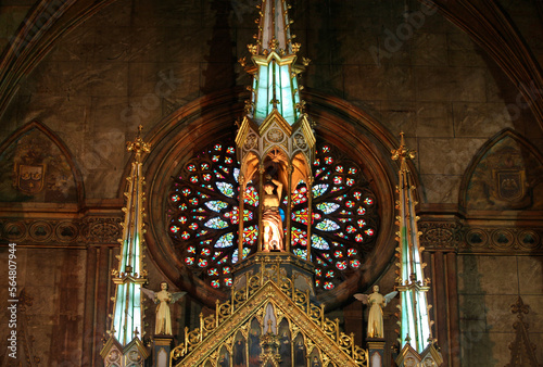 Statues and old painted glass window in San Sebastian Church, Manila, Philippines photo