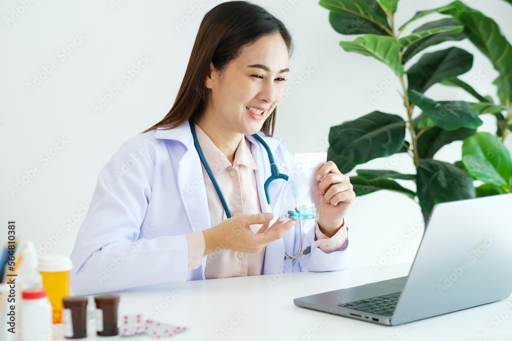 Asian woman doctor make video call counselling her patient about healthcare by laptop computer, Telemedicine, Pharmacist Asian woman doctor make video call counselling her patient about healthcare by laptop computer, Telemedicine, Pharmacist