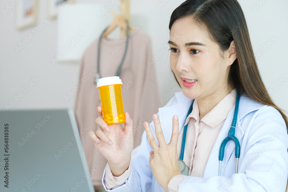 Asian woman doctor make video call counselling her patient about healthcare by laptop computer, Telemedicine, Pharmacist Asian woman doctor make video call counselling her patient about healthcare by laptop computer, Telemedicine, Pharmacist