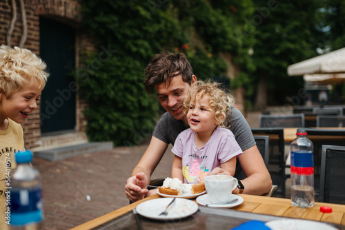 Young family having fun at a cafe outdoors