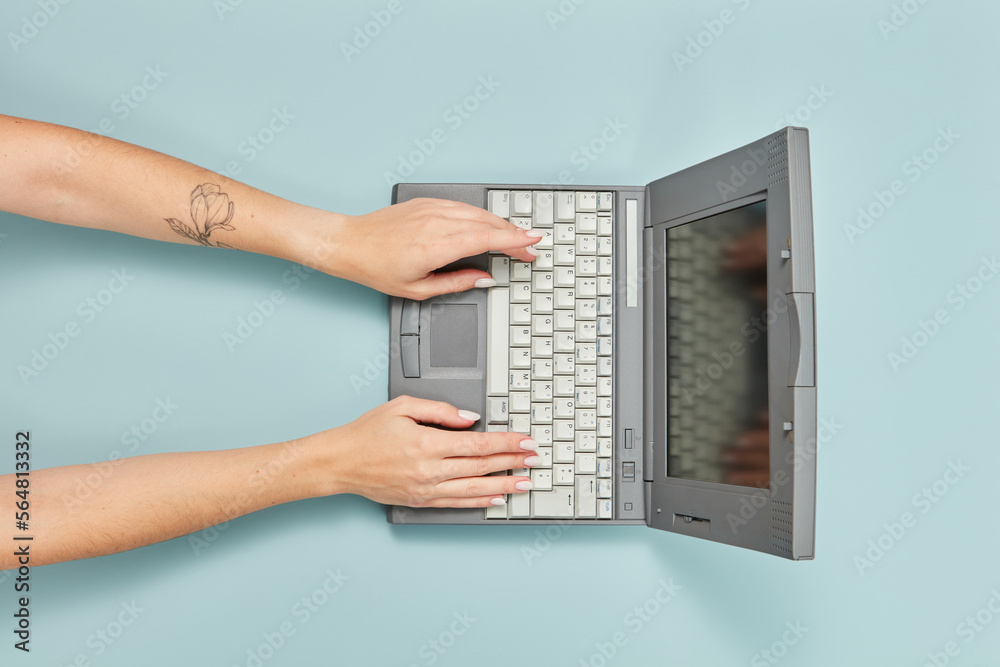 90s laptop with hands of working woman. 90s laptop with hands of working woman.