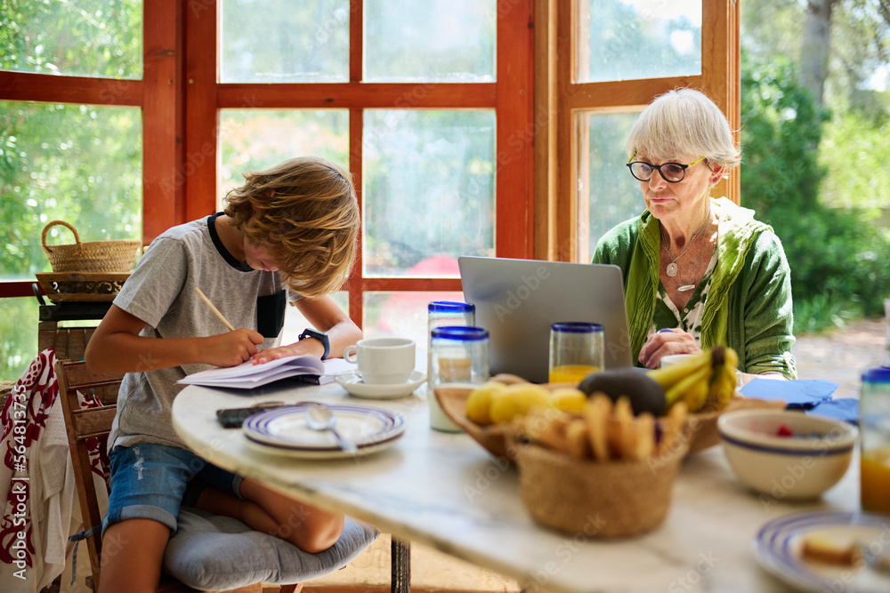 Busy grandmother and grandson at table Busy grandmother and grandson at table