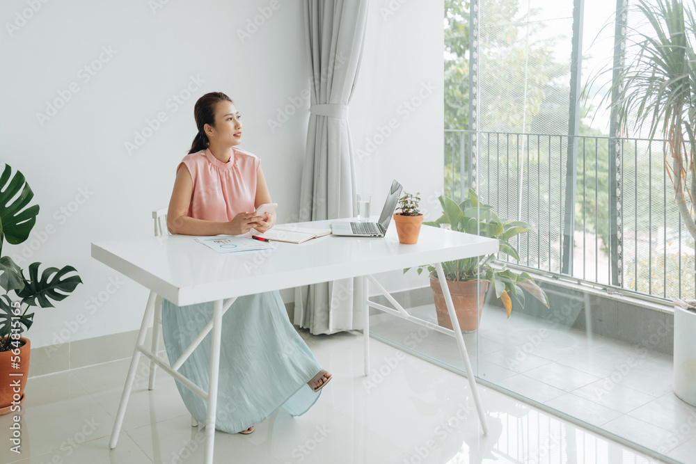 Asian businesswoman working on accounting with smartphone Asian businesswoman working on accounting with smartphone
