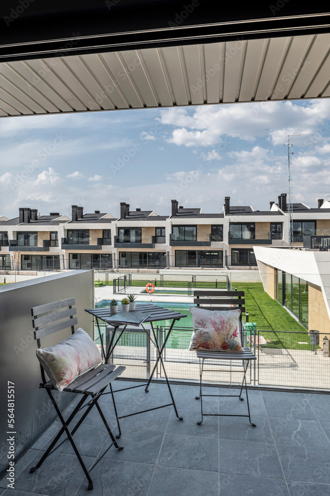 Modern balcony with luxury residential complex views at daytime Modern balcony with luxury residential complex views at daytime