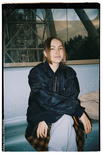A beautiful woman riding a white ferris wheel
