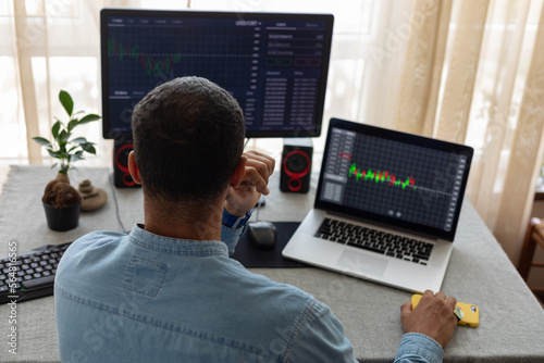 man behind two monitors photo