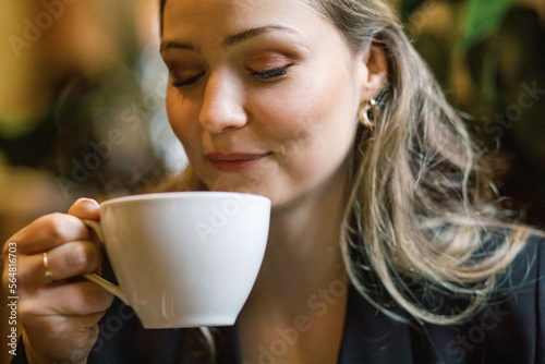 Woman enjoying a cup of coffee photo