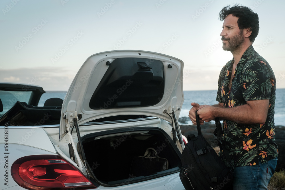 Man taking backpack from car Man taking backpack from car